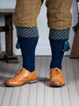 A contemporary technical shooting sock with supportive foot arch in navy blue with ancient blue and mulberry pattern in the turnover