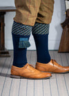 A contemporary technical shooting sock with supportive foot arch in navy blue with ancient blue and mulberry pattern in the turnover