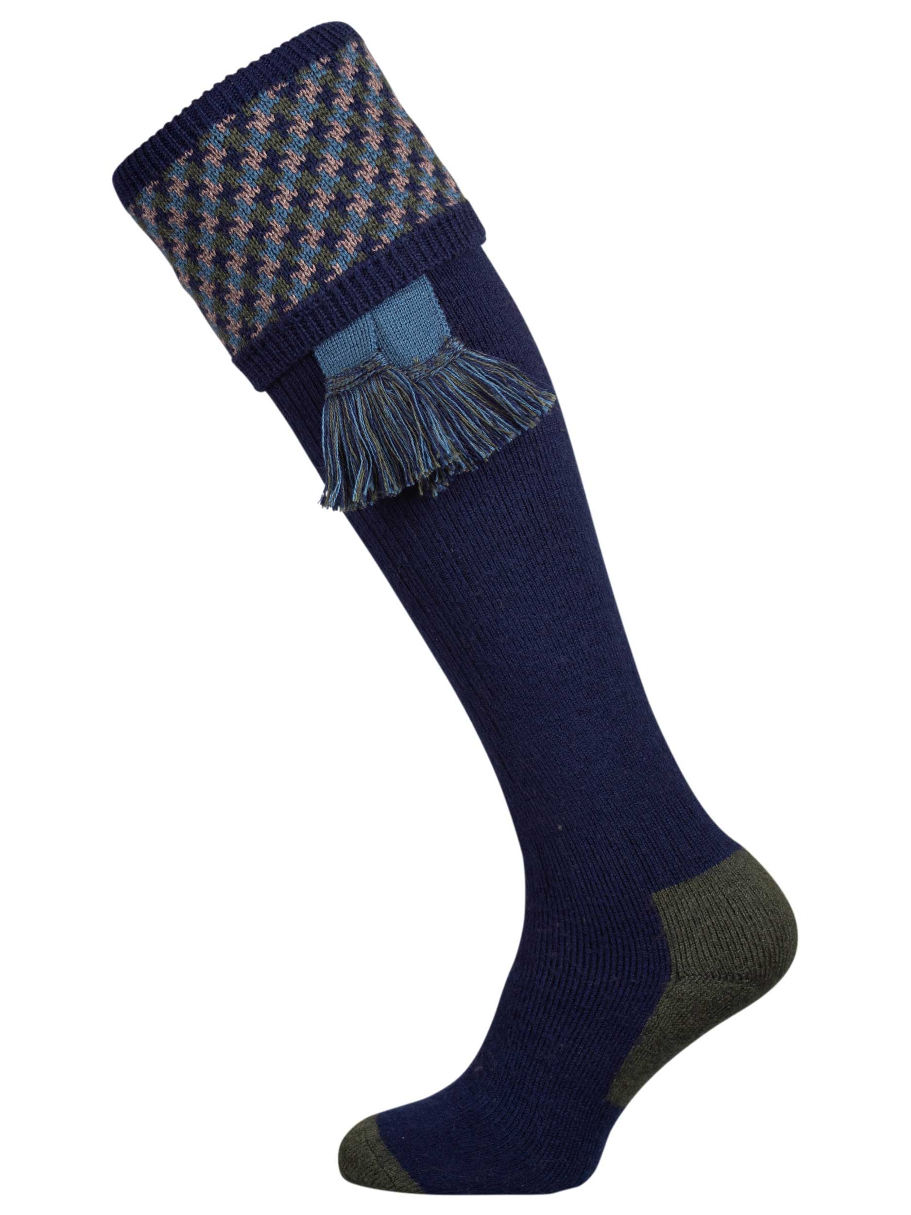 A contemporary technical shooting sock with supportive foot arch in navy blue with ancient blue and mulberry pattern in the turnover