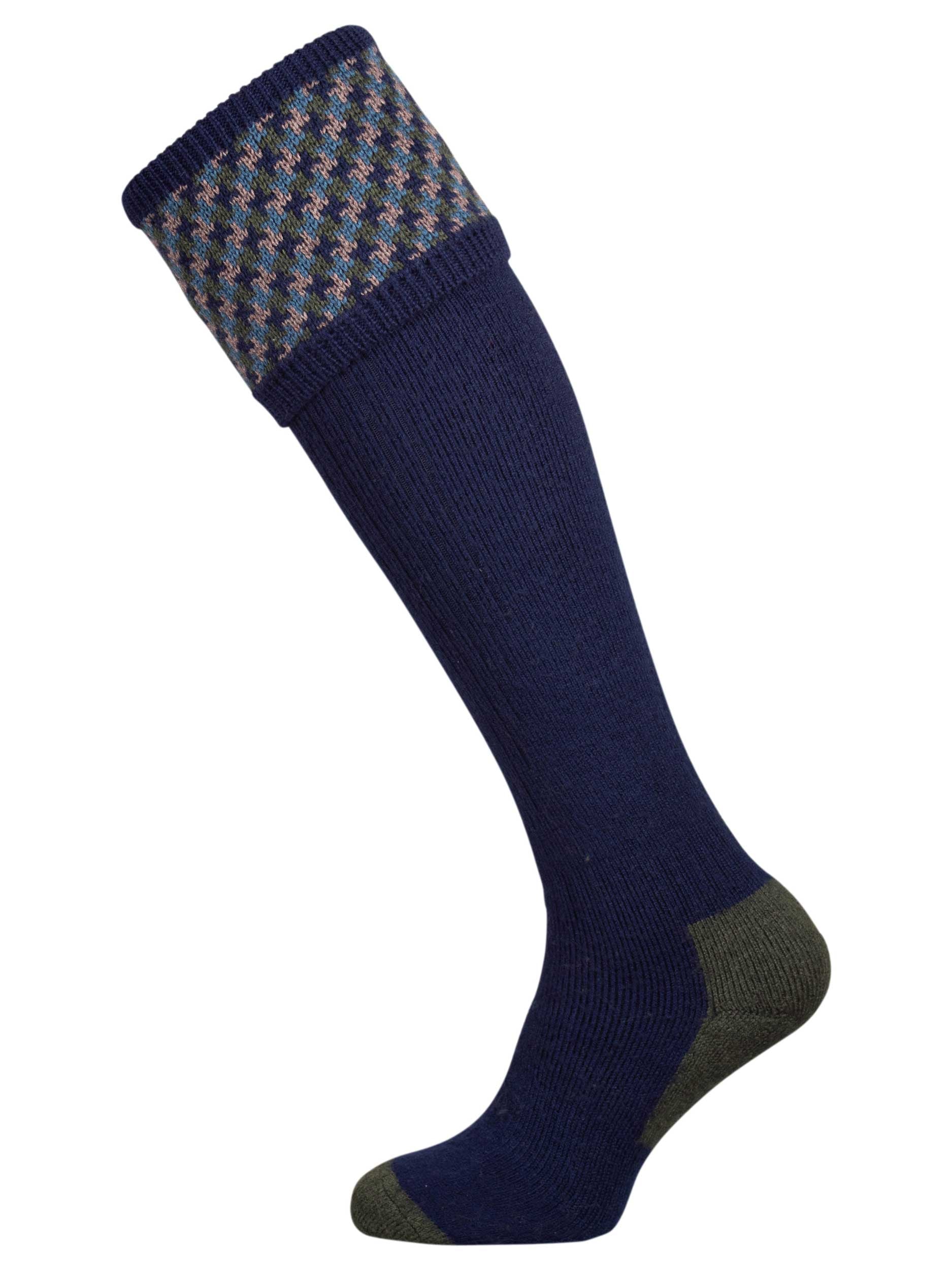 A contemporary technical shooting sock with supportive foot arch in navy blue with ancient blue and mulberry pattern in the turnover