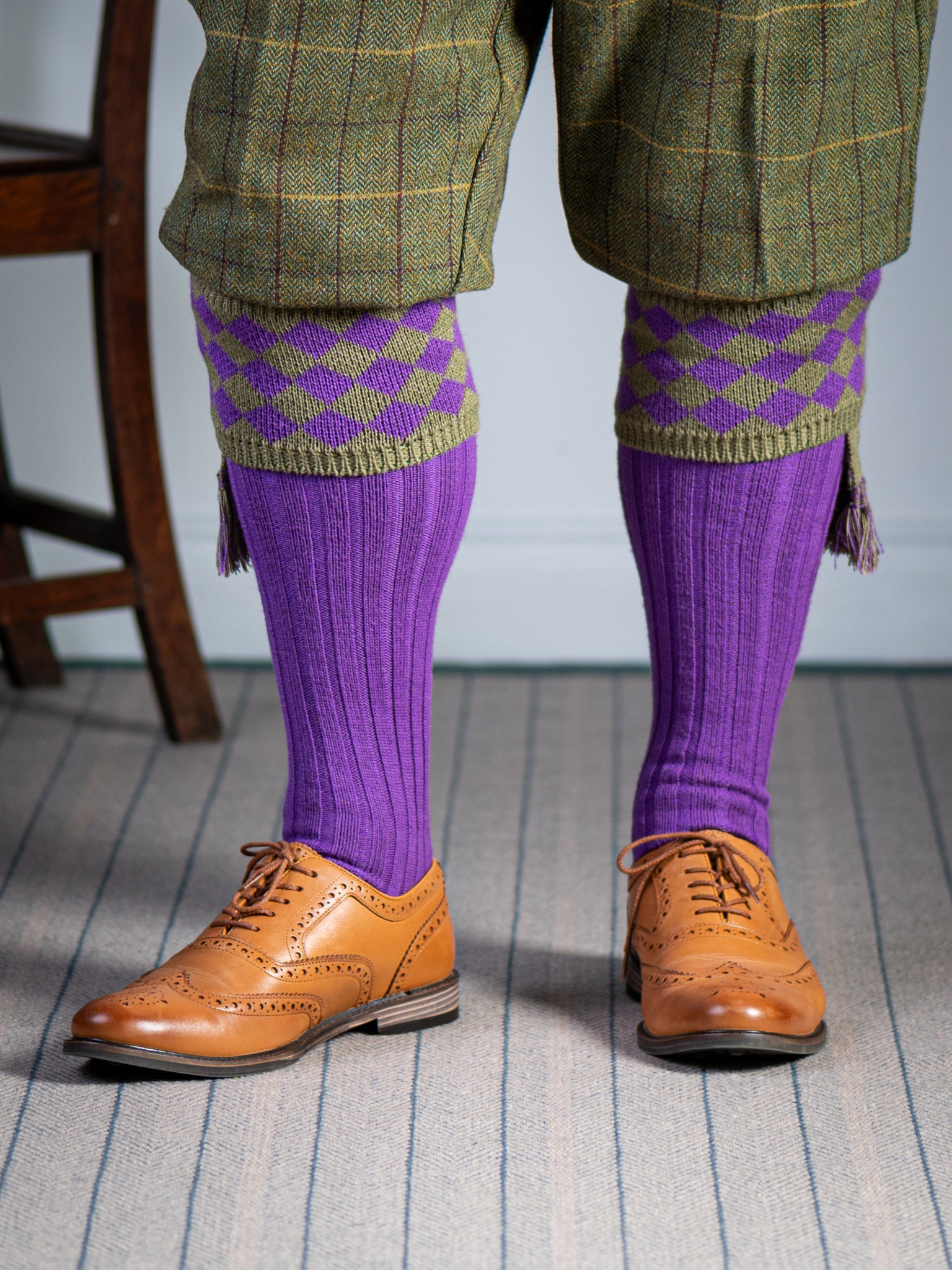 Traditional knitted shooting socks with ribbed leg in bright purple with a fern green chequer board pattern in the turnover