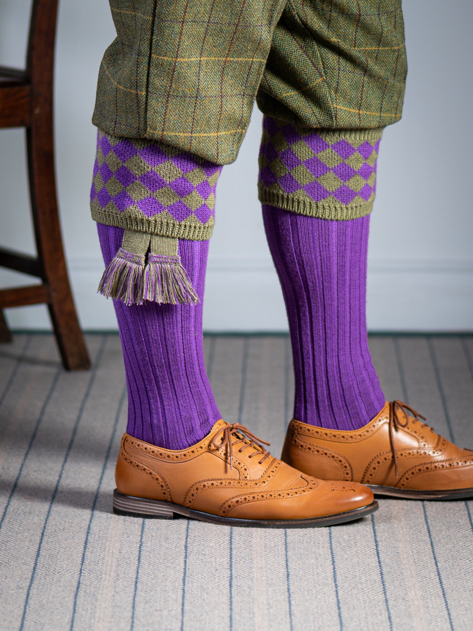 Traditional knitted shooting socks with ribbed leg in bright purple with a fern green chequer board pattern in the turnover