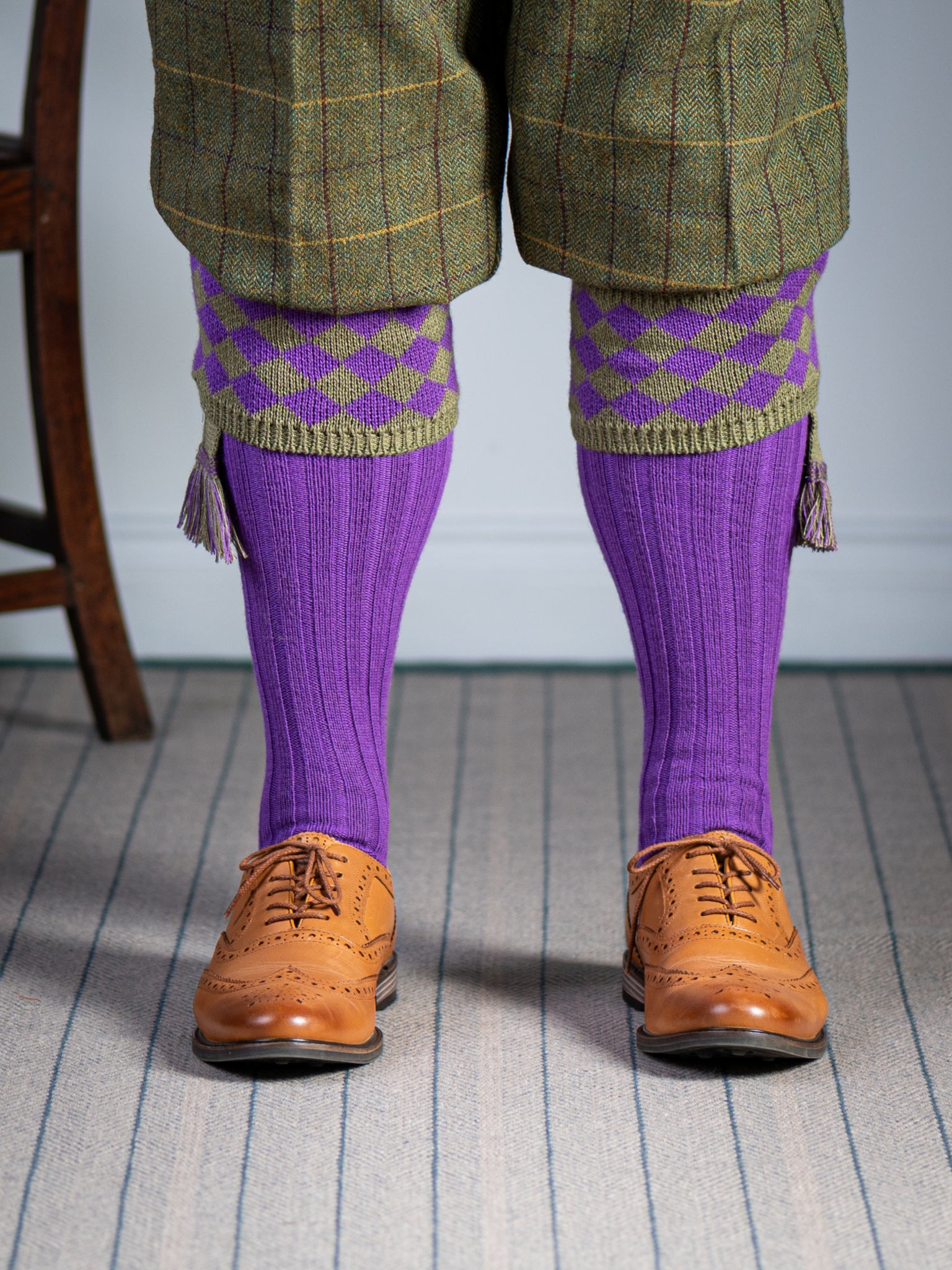 Traditional knitted shooting socks with ribbed leg in bright purple with a fern green chequer board pattern in the turnover