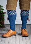 Long knitted shooting socks in mid blue with a ribbed leg, features 4 different colours in the argyle pattern turnover top.