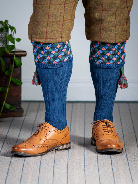 Long knitted shooting socks in mid blue with a ribbed leg, features 4 different colours in the argyle pattern turnover top.