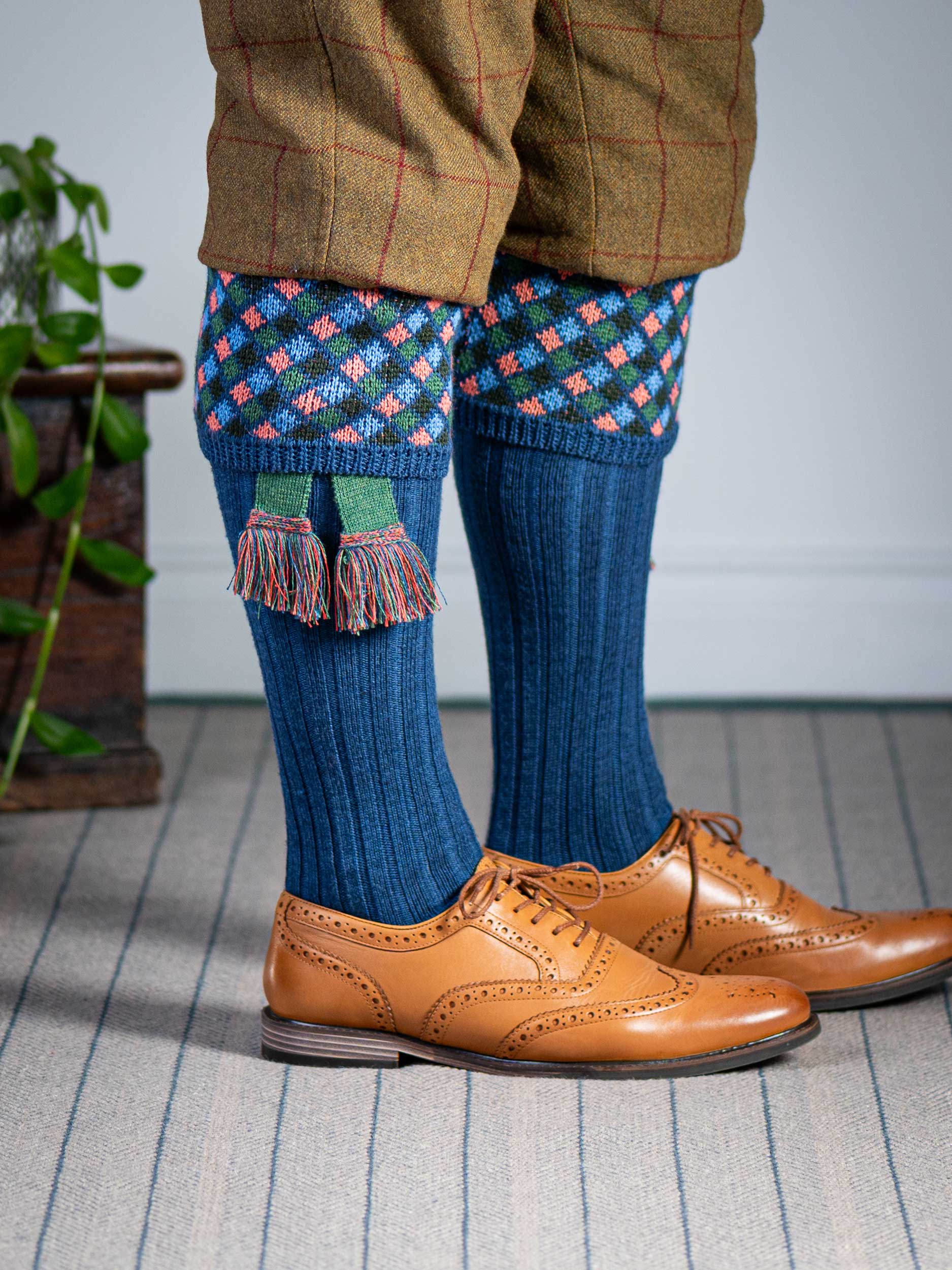 Long knitted shooting socks in mid blue with a ribbed leg, features 4 different colours in the argyle pattern turnover top.