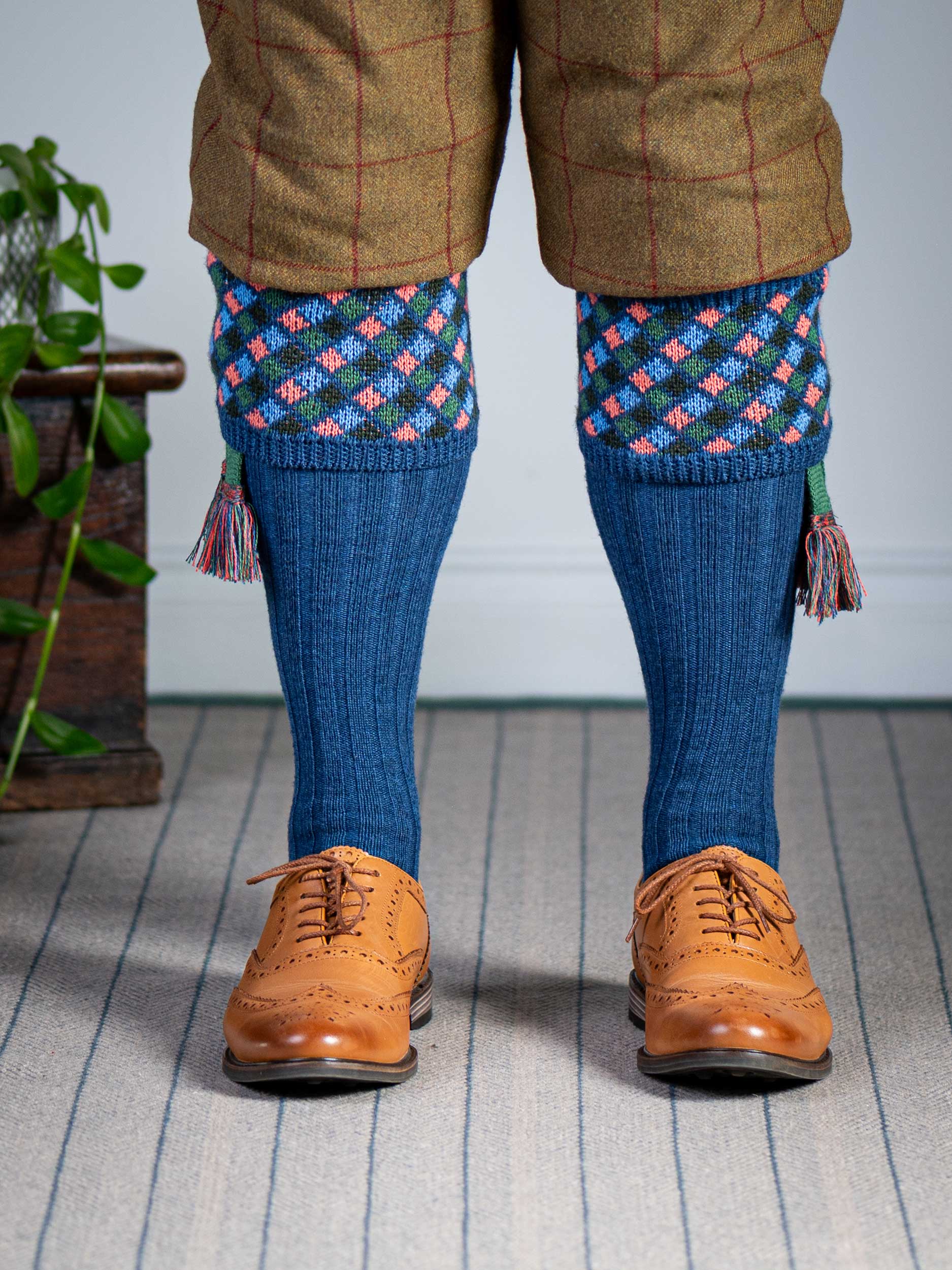 Long knitted shooting socks in mid blue with a ribbed leg, features 4 different colours in the argyle pattern turnover top.