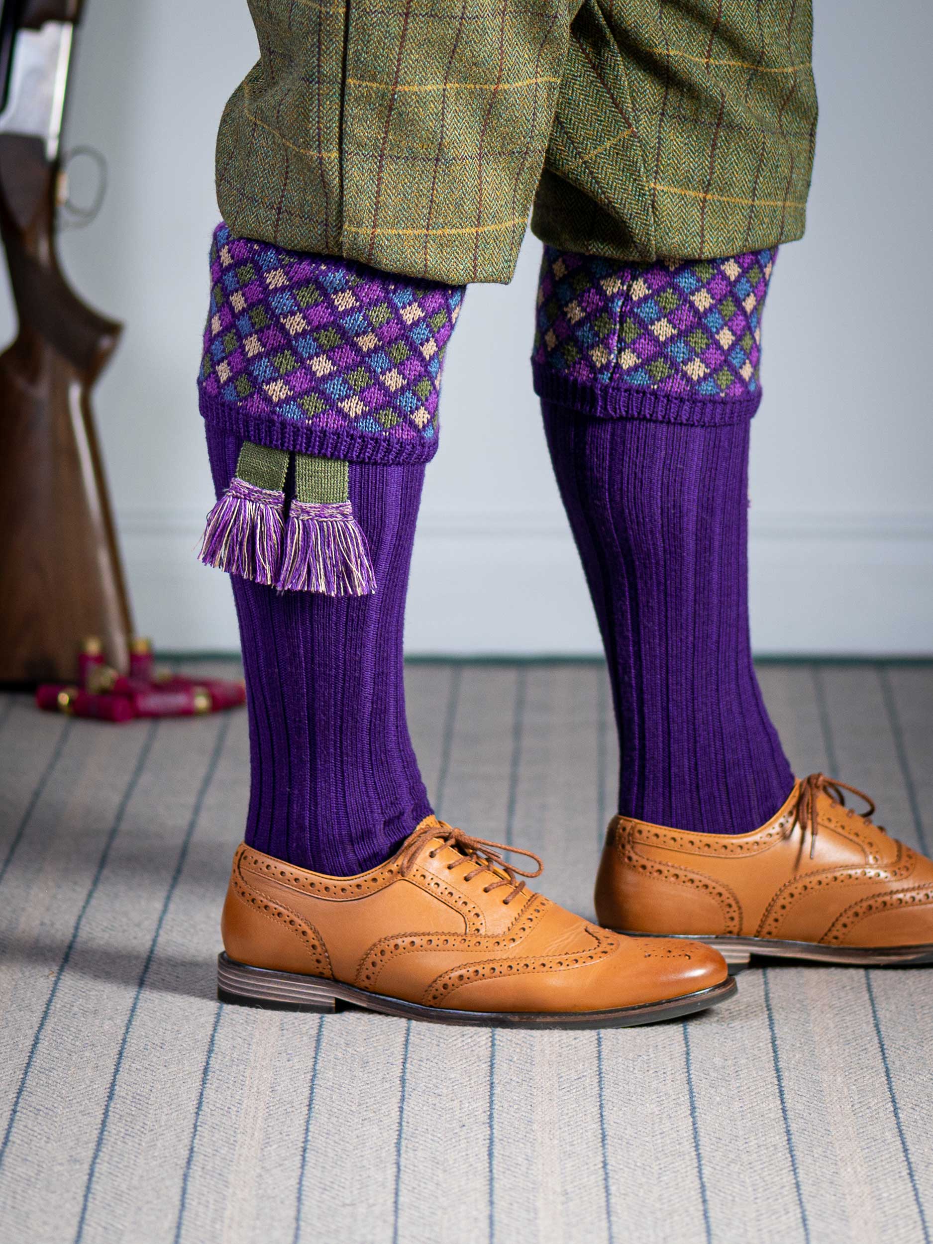 Long knitted shooting socks in bright purple with a ribbed leg, features 4 different colours in the argyle pattern turnover top.