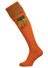 Traditional knitted shooting socks with ribbed leg in burnt orange with a herringbone pattern in the turnover