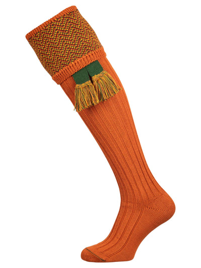 Traditional knitted shooting socks with ribbed leg in burnt orange with a herringbone pattern in the turnover