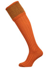 Traditional knitted shooting socks with ribbed leg in burnt orange with a herringbone pattern in the turnover