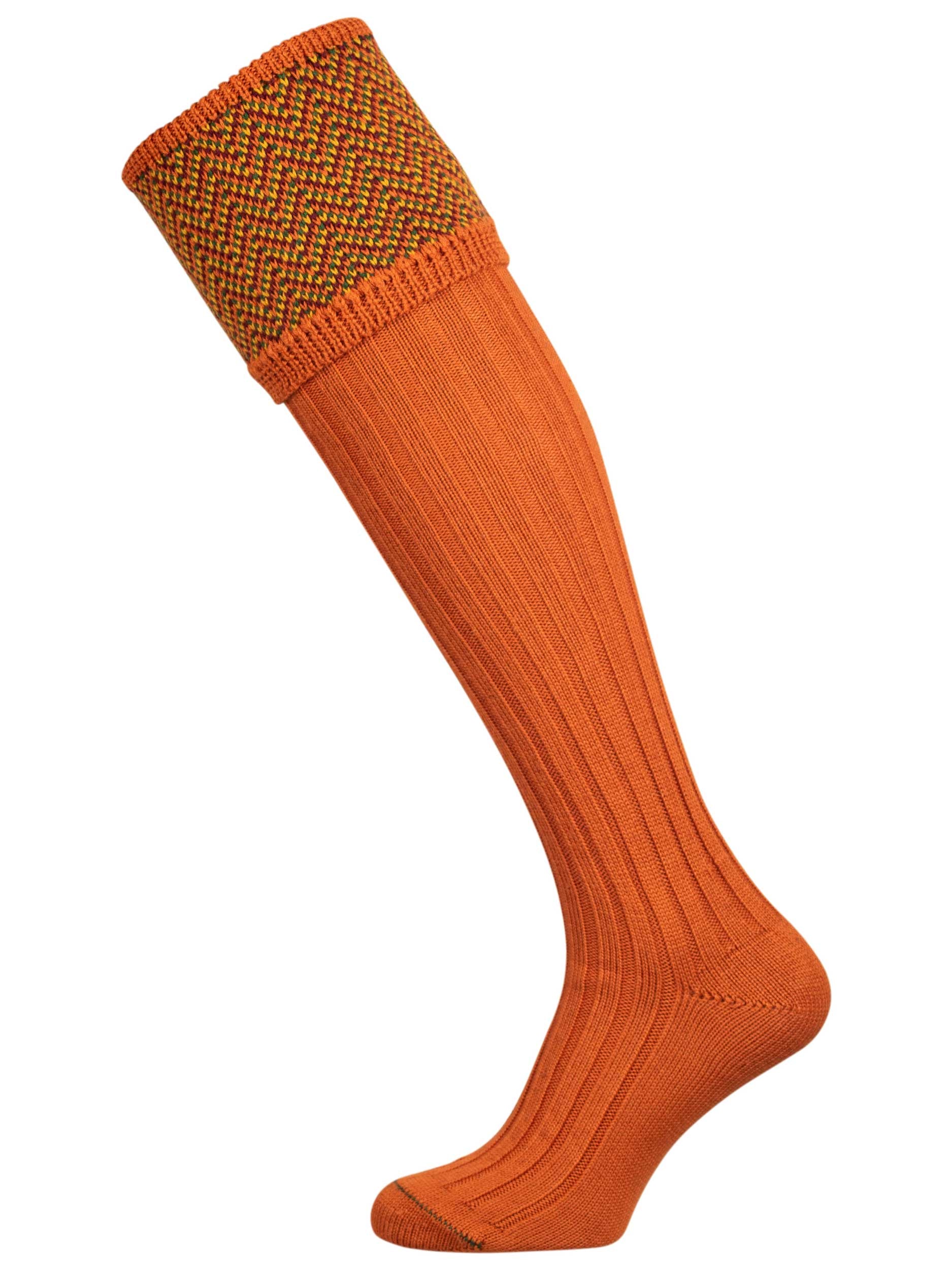 Traditional knitted shooting socks with ribbed leg in burnt orange with a herringbone pattern in the turnover