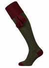 Dark green shooting sock with cable knit detail in the leg and deep burgundy turnover with optional burgundy garter tie.