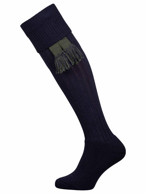 Long knitted merino wool socks in navy blue with optional green garter tie