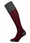 Full length knitted sock in burgundy with a green turnover top.