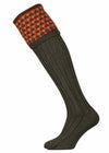 Merino wool shooting sock in deep hunter green with burnt orange and camel pattern.