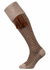 A dark brown and oatmeal houndstooth leg shooting sock with optional almond garter