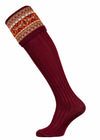 A deep burgundy shooting sock with fairisle knit pattern including oranges and greens.
