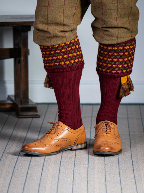 Long knitted shooting socks in burgundy with a ribbed leg, features 2 different colours in the textured knit top
